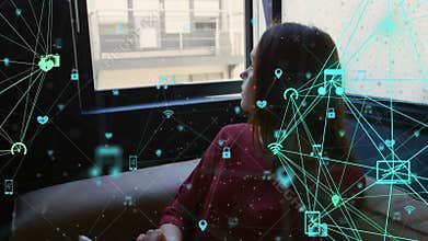 Animation of connected icons forming globes over caucasian woman using digital tablet