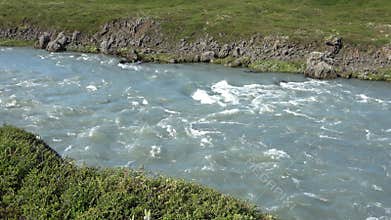 Fantastic landscape with flowing rivers and streams with rocks and grass in Iceland