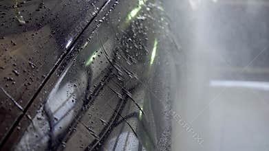 Close-up of interior cleaning in a car. A worker dirty car water blaster with a vacuum cleaner. Car washing cleaning.