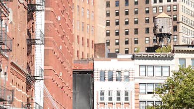 New York City Manhattan architecture, USA. Residential house exterior. Red brick facade, water tower