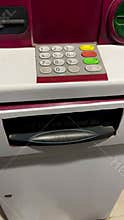 Modern banking footage depicting a secure cash withdrawal process via debit card.