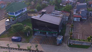 Aerial view showing a Kawasaki store in Depok, Indonesia, with its green branding, showroom facade