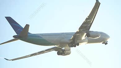 Bali, 5 June 2019: An airplane takes off from Ngurah Rai International Airport, Bali, soaring into clear blue skies, marking the