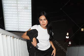 Portrait of young beautiful fashion model at night