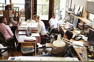 Interior Of Busy Architect's Office With Staff Working