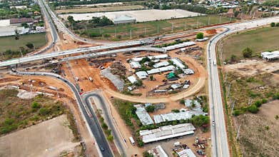 Drone shot of highway and overpass construction site with vehicles and road for infrastructure civil industry