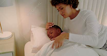 African American mother noticing daughter fever using thermometer and tucking duvet in bedroom