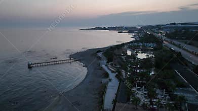 Stunning aerial sunset to night transition over Turkler in Alanya, Turkey. Alanya coastline,resorts,marina,hotels and city lights