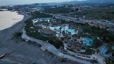 Stunning aerial sunset to night transition over Turkler in Alanya, Turkey. Alanya coastline,resorts,marina,hotels and city lights