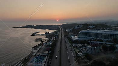 Stunning aerial sunset to night transition over Turkler in Alanya, Turkey. Alanya coastline,resorts,marina,hotels and city lights