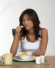 Asian woman eating fruit