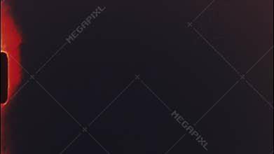 Vintage super 8 film leader revealing red and black colors with organic light leaks, generating nostalgic cinematic texture