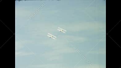 Vintage biplanes performing aerobatics in the uk sky