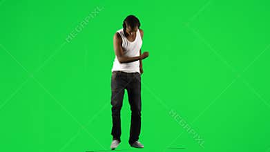 Ethnic boy with a headset on dancing music against green screen