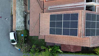 Solar energy with cell panels or PV modules installed on top of house rooftop.