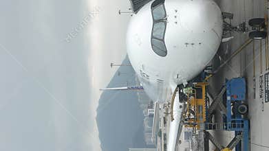 View at airside in HKG Hongkong Airport while ground service staffs loaders doing ground service operation of Philippines airline
