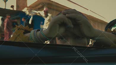 View from inside the car of a small girl wearing beautiful bangles, begging in Chichawatni, Pakistan