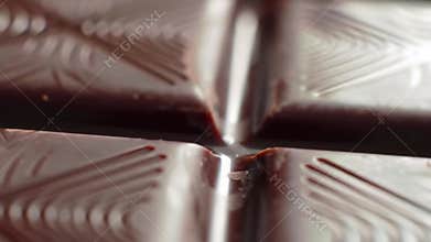 Extreme Close-Up Macro Shot of Dark Chocolate Bar Segments with Intricate Patterns, Slow Motion