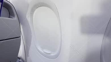Passenger adjusting airplane window, porthole shade during flight. Minimalistic interior, bright