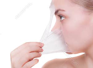 Portrait blond girl in facial mask. Beauty and skin care.