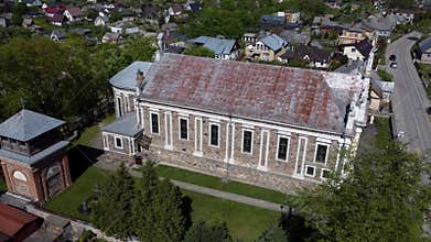 Drone footage of the Church of the Holy Apostles Peter and Paul on a sunny day in Ukmerge, Lithuania