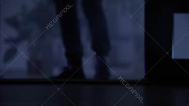 male burglar sneaking into room to steal valuables, close up