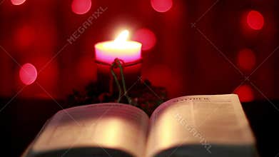 Christmas candle and open Bible