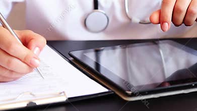Doctor writing a prescription using digital tablet pc