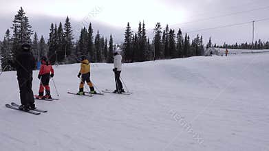 Families children and adults leisure on ski holiday