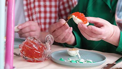 woman making red caviar toasts