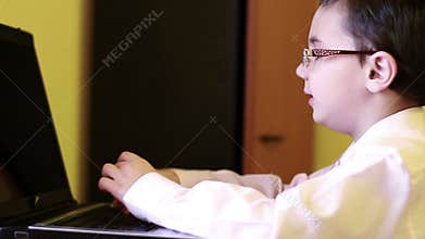 Little boy at the laptop computer