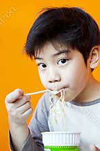 Asian cute boy with noodle cup