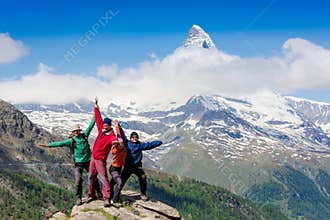 Team of hikers on the rocky summit
