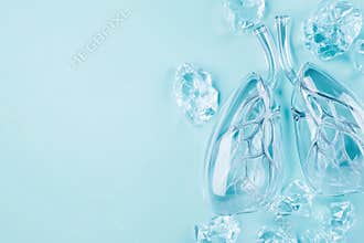 Transparent glass lungs with ice crystals on light blue background symbolizing fresh breath and purity, AI Generative