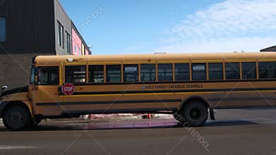 Yellow school buses transporting public school students on snow day.