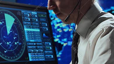 Professional air traffic controller in the control tower. Aircraft control officer works using radar, computer navigation and