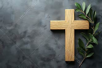 A wooden cross accompanied by an olive branch symbolizes faith and hope