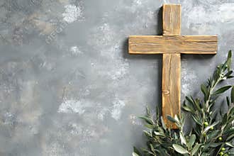 A wooden cross accompanied by an olive branch set against a textured background, ideal for religious themes