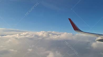 An airplane flying above the clouds is a scene of air travel.