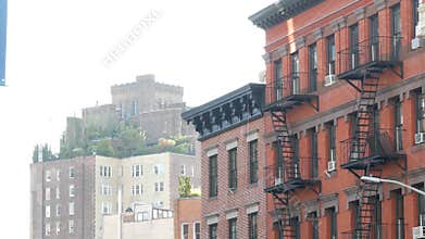 New York City building architecture, Manhattan. Residential house exterior. Red brick, fire escape.