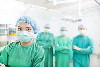 Smiling surgeon posing with aesthetic medicine teams