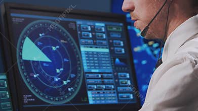 Professional air traffic controller in the control tower. Aircraft control officer works using radar, computer