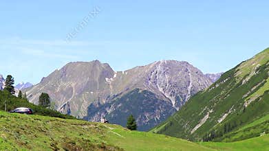 Alpine mountain and hill landscape panorama blue sky Tyrol Austria