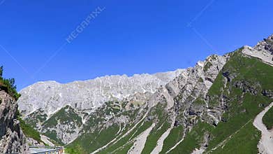 Driving through mountain landscape rocks hill blue sky Tyrol Austria