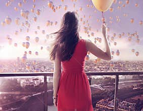 Young woman staring at thousands of the balloons