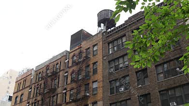New York City building architecture. Residential house exterior. USA real estate. Rooftop water tower