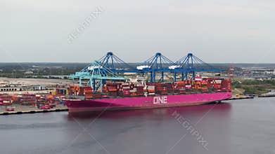 Freight containers for international shipment of produced goods. Unloading container ship in port of Savannah, Georgia.