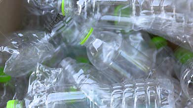 Plastic waste, Throwing a plastic waste bottle into a cardboard box, representing recycling, waste plastic sorting, and