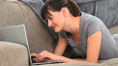 Brunette enjoying a chat on a laptop