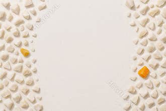 A textured backdrop featuring small irregular pebbles and two vibrant orange spheres centered